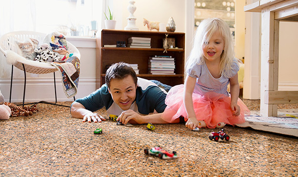 Father and daughter with toy cars